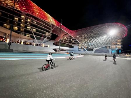 Niños y adultos en bicicleta en el circuito de Fórmula 1 de Abu Dabi