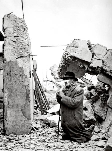 Un hombre reza junto a las ruinas de su casa tras el terremoto de Valdivia, mayo de 1960