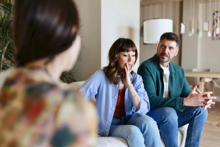 Teenage girl talking with her worried parents