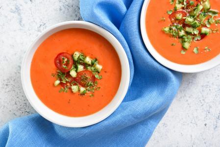 Dos cuencos con gazpacho y verduras troceadas