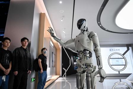 Xpeng's next-gen Iron humanoid robot talks during a showroom tour at its headquarter in Guangzhou, in southern China's Guangdong province on November 5, 2025. (Photo by Jade GAO / AFP)