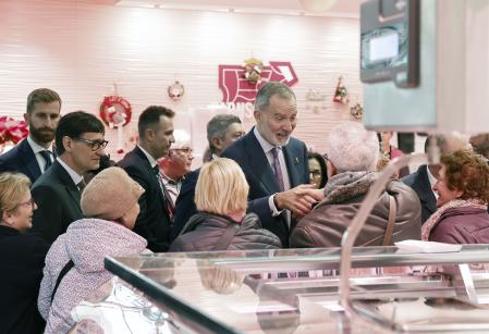 El Rey saluda a los vecinos y tenderos que le han recibido en el mercado municipal del barrio de La Florida de 