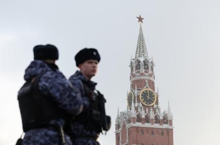Russian law enforcement officers stand guard near the Spasskaya Tower of the Kremlin in central Moscow, Russia, December 29, 2025. REUTERS/Ramil Sitdikov
