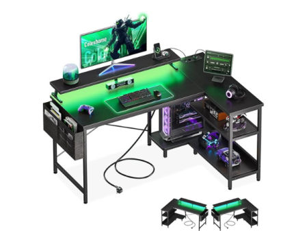 Escritorio gaming en forma de L con iluminación LED verde, estantes y espacio para monitor y PC.