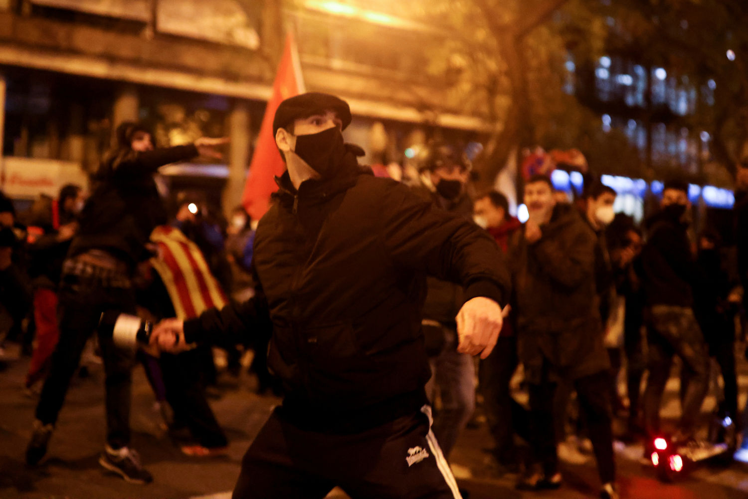 Supporters of Catalan rap singer Pablo Hasel take part in a protest against his arrest, after he was given a jail sentence on charges of glorifying terrorism and insulting royalty in his songs, in Barcelona, Spain, February 16, 2021. REUTERS/Nacho Doce