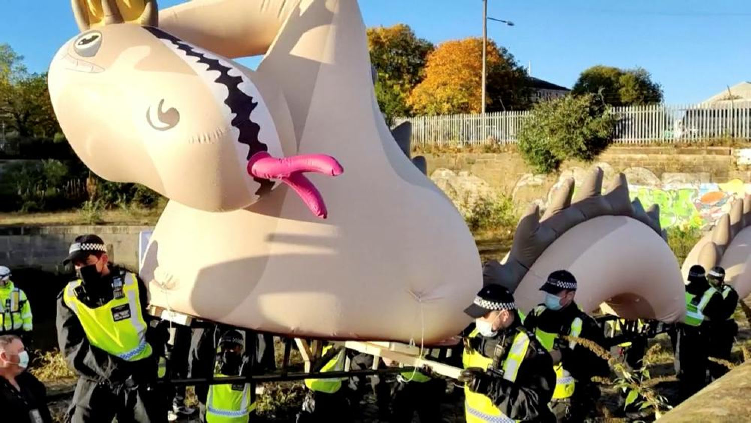 Agentes de policía se llevan un monstruo inflable gigante del lago Ness de una protesta cerca de la sede de la Conferencia de las Naciones Unidas sobre el Cambio Climático