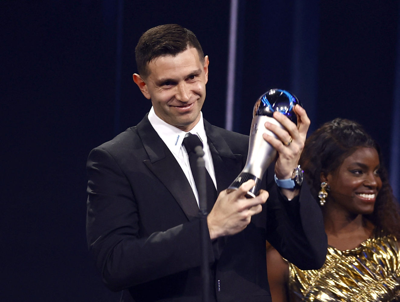 Soccer Football - The Best FIFA Football Awards - Salle Pleyel, Paris, France - February 27, 2023 Aston Villa's Emilio Martinez receives the Best Goalkeeper award from Enjola Aluko during the Best FIFA Football Awards. REUTERS/Sarah Meyssonnier