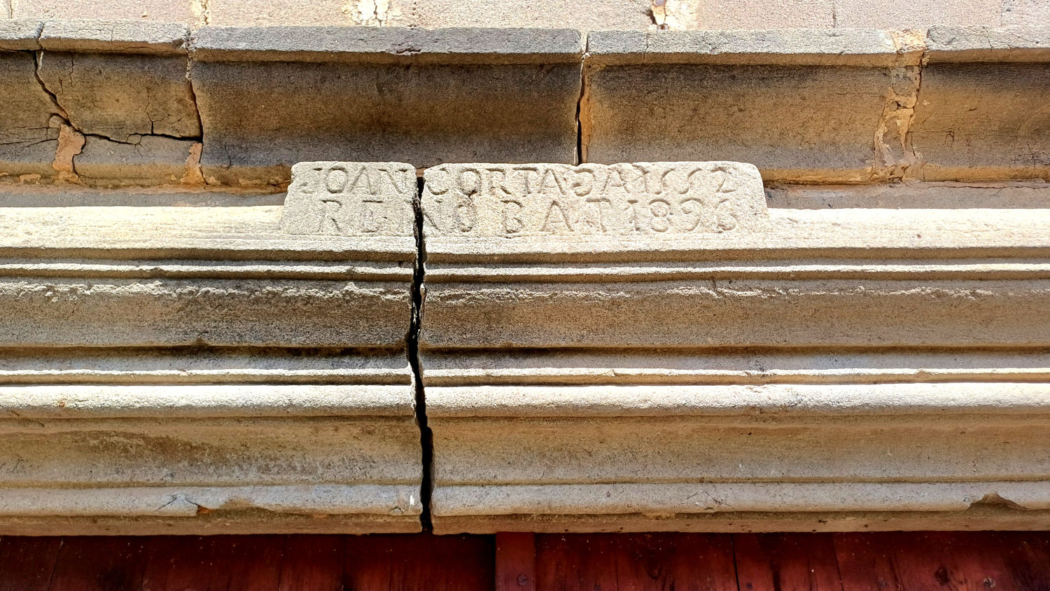 Inscripción ubicada en la parte superior de la puerta.