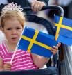 Una niña muestra la bandera sueca de cara a la celebración de la boda de la princesa heredera Victoria de Suecia y su prometido, Daniel Westling, en Estocolmo