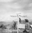 The British Army In Burma 1944, A member of the Worcestershire Yeomanry views an amusing roadsign beside an ancient standing stone at 'Stonehenge Camp' on the Imphal to Kohima road. The sign reads 'Worcester, 5100 miles & No Way Out' and 'Tokyo, 2,800 miles & Way Out', November 1944. (Photo by No 9 Army Film & Photographic Unit/ Imperial War Museums via Getty Images)