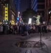 Wuhan (China), 22/01/2021.- People listen to musicians performing in a commercial walking street, in Wuhan, China, 22 January 2021. The 23 January 2021 marks the one-year anniversary of the start of a strict 76-day lockdown of the Chinese city of Wuhan, where the coronavirus was first discovered before spreading across the world into a deadly global Covid-19 pandemic. EFE/EPA/ROMAN PILIPEY