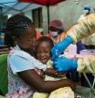 FILE - In this Saturday, July 13, 2019 file photo, a child is vaccinated against Ebola in Beni, Congo. The World Health Organization and other partners said Tuesday Jan. 12, 2021, they are creating a global emergency stockpile of about 500,000 vaccines of Ebola vaccines to help stamp out any future outbreaks of the disease.(AP Photo/Jerome Delay, file)