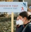 OBERSTDORF, GERMANY - FEBRUARY 23: Accredited people pass a signpost showing the way to the Covid-19 Corona test center during the FIS Nordic World Ski Championships 2021 in Oberstdorf on February 23, 2021 in Oberstdorf, Germany. (Photo by Matthias Hangst/Getty Images)