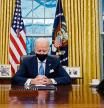 US President Joe Biden sits in the Oval Office at the White House in Washington, DC, after being sworn in at the US Capitol on January 20, 2021. - US President Joe Biden signed a raft of executive orders to launch his administration, including a decision to rejoin the Paris climate accord. The orders were aimed at reversing decisions by his predecessor, reversing the process of leaving the World Health Organization, ending the ban on entries from mostly Muslim-majority countries, bolstering environmental protections and strengthening the fight against Covid-19. (Photo by Jim WATSON / AFP)