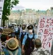 Protesters against the Tokyo Olympics gather outside Akasaka Palace, Japanese state guest houseÂ where the welcome party for IOC President Thomas Bach and its officials are held in Tokyo, Japan, Sunday, July 18, 2021. The one of banners reads 