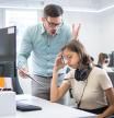 Business executive yelling at his female employee in the office.