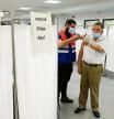 An elderly man receives a coronavirus disease (COVID-19) vaccine booster coinciding with the flu vaccination campaign in Seville, Spain October 18, 2021. REUTERS/Marcelo del Pozo