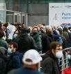 People queue to get their dose of the coronavirus disease (COVID-19) vaccine outside a vaccination centre in Madrid, Spain, November 24, 2021. REUTERS/Sergio Perez