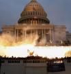 FILE PHOTO: An explosion caused by a police munition is seen while supporters of U.S. President Donald Trump riot in front of the U.S. Capitol Building in Washington, U.S., January 6, 2021. REUTERS/Leah Millis/File Photo