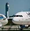 (FILES) In this file photo taken on May 31, 2021 Parked aircrafts operated by German airline Lufthansa are pictured at Berlin Brandenburg BER airport Willy-Brandt in Schoenefeld near Berlin on May 31, 2021. - German national carrier Lufthansa will cut its winter flight plan by 