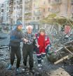SENSITIVE MATERIAL. THIS IMAGE MAY OFFEND OR DISTURB People and medics help a wounded resident of a house destroyed by shelling as Russia's attack on Ukraine continues, in Kyiv, Ukraine March 14, 2022. REUTERS/Gleb Garanich