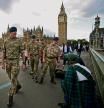 Royal Air Force members walk the perimeter near Westminster Palace in London, Friday, Sept. 16, 2022. Queen Elizabeth, Britain's longest-reigning monarch and a rock of stability across much of a turbulent century, died Thursday Sept. 8, after 70 years on the throne. She was 96. (Nathan Denette /The Canadian Press via AP)