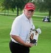 Former President Donald Trump holds a March 1990 issue of Playboy magazine with him on the cover, given to him by a fan, during the pro-am of the LIV Golf Team Championship at Trump National Doral Golf Club in Doral, Fla., on Thursday, Oct. 27, 2022. (AP Photo/Lynne Sladky)