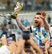 LUSAIL CITY, QATAR - DECEMBER 18: Lionel Messi of Argentina celebrates with the FIFA World Cup Qatar 2022 Winner's Trophy after the team's victory during the FIFA World Cup Qatar 2022 Final match between Argentina and France at Lusail Stadium on December 18, 2022 in Lusail City, Qatar. (Photo by Julian Finney/Getty Images)