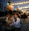 A couple looks at a phone, as other people wear protective face masks to avoid the spread of the coronavirus disease (COVID-19), at an amusement park in Seoul, South Korea April 30, 2020.    REUTERS/Kim Hong-Ji