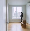 Teenager girls, sisters, looking around the new empty apartment in Brooklyn, New York