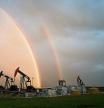 A rainbow appears to come down on pumpjacks drawing out oil and gas from wells near Calgary, Alberta, Monday, Sept. 18, 2023. Canada has the third largest oil reserves in the world and is the world's fourth largest oil producer. (Jeff McIntosh/The Canadian Press via AP)