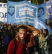 A supporter of Argentina's Economy Minister Sergio Massa holds his head after the conceded defeat to opposition candidate Javier Milei in the presidential runoff election in Buenos Aires, Argentina, Sunday, Nov. 19, 2023. (AP Photo/Matias Delacroix