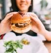 Woman eating beef burger