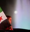 A girl holds a Syrian flag during celebrations of the first anniversary of the ousting of the Bashar Assad regime in Damascus, Syria, early Saturday, Dec. 6, 2025. (AP Photo/Omar Sanadiki)