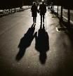 A couple walk along a boulevard in Barcelona, Spain, Sunday, Jan. 17, 2021. Scientists say it's still too early to predict the future of the coronavirus, but many doubt it will ever go away entirely. (AP Photo/Emilio Morenatti)