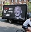 A video protest sign on a truck paid for by the Patriotic Millionaires drives past a mansion owned by Amazon founder Jeff Bezos as part of a federal tax filing day protest to demand he pay his fair share of taxes, in Washington, U.S. May 17, 2021. REUTERS/Jonathan Ernst