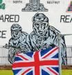 A British Union flag, also known as a Union Jack, in front of an Ulster Volunteer Force (UVF) mural in in North Belfast, Northern Ireland, U.K., on Wednesday, June 9, 2021. Officials from Britain and the European Union are meeting on Wednesday to try and defuse a row over Northern Ireland that threatens to spill over into this week#{emoji}146;s Group of Seven summit. Photographer: Paul Faith/Bloomberg