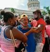 A man is arrested during a demonstration against the government of Cuban President Miguel Diaz-Canel in Havana, on July 11, 2021. - Thousands of Cubans took part in rare protests Sunday against the communist government, marching through a town chanting 