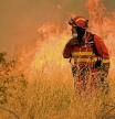 A firefighter operates at the site of a wildfire in Navalmoral de la Sierra near Avila, central Spain, on August 16, 2021. - A thousand people were evacuated and more than 5,000 hectares burned from 11am, with flames spreading up over a 40-kilometer perimeter. Spain saw its highest temperature on record on Saturday as a heatwave on the Iberian peninsula drove the mercury to 47.4 degrees Celsius (117.3 Fahrenheit), according to provisional data from the state meteorological agency. (Photo by CESAR MANSO / AFP)