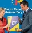 EU Commission President Ursula von der Leyen, left, and Spain's Prime Minister Pedro Sanchez hold the Next Gen EU agreement during a press conference in Alcobendas, outskirts of Madrid, Spain, Wednesday, June 16, 2021. (AP Photo/Bernat Armangue, Pool)