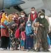 Afghan people who were transported from Afghanistan, walk after disembarking a plane, at the Torrejon military base as part of the evacuation process in Madrid, Spain, Tuesday, Aug. 24, 2021. (AP Photo/Andrea Comas)