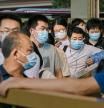 BEIJING, CHINA - AUGUST 27: Commuters wait in line for public buses as they leave work in the business district on August 27, 2021 in Beijing, China. China's Supreme People's Court ruled this week that its illegal for companies to subject employees to the practice known as 996