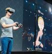 Facebook co-founder and chief executive, Mark Zuckerberg, speaks at an Oculus developers conference while wearing a virtual reality headset in San Jose, California on October 6, 2016. - Facebook unveiled new hardware for its Oculus division as part of a stepped-up effort to integrate virtual reality with the leading social network. The new offerings aim to get an array of virtual reality gear to consumers in the coming months, including a new 