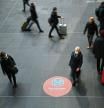 A sign with the request to keep distance is seen at central station during the spread the coronavirus disease (COVID-19) in Berlin, Germany, November 17, 2021. REUTERS/Annegret Hilse