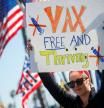 A woman holds a sign as various activist groups hold a rally at the Huntington Beach Pier to speak out against COVID-19 vaccine mandates for school children and workers that may be mandated by State legislature in the coming year, amid the coronavirus disease (COVID-19) pandemic, in Huntington Beach, California, U.S., January 3, 2022. REUTERS/Mike Blake