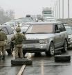 Kazakh law enforcement officers stand guard at a checkpoint, after mass protests triggered by fuel price increase erupted all over the country, in Almaty, Kazakhstan January 8, 2022. REUTERS/Pavel Mikheyev