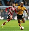 WOLVERHAMPTON, ENGLAND - JANUARY 09: Adama Traore of Wolverhampton Wanderers runs with the ball during the Emirates FA Cup Third Round match between Wolverhampton Wanderers and Sheffield United at Molineux on January 09, 2022 in Wolverhampton, England. (Photo by Shaun Botterill/Getty Images)