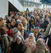 People crowd as they try to get on a train to Lviv at the Kyiv station, Ukraine, Friday, March 4. 2022. Ukrainian men have to stay to fight in the war while women and children are leaving the country to seek refuge in a neighboring country. (AP Photo/Emilio Morenatti)