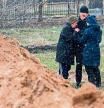 TOPSHOT - People react as they gather close to a mass grave in the town of Bucha, just northwest of the Ukrainian capital Kyiv on April 3, 2022. - President Volodymyr Zelensky accused Russia of committing genocide and attempting to eliminate the 