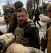 FILE PHOTO: Ukraine's President Volodymyr Zelenskiy looks on as he is surrounded by Ukrainian servicemen as Russia's invasion of Ukraine continues, in Bucha, outside Kyiv, Ukraine, April 4, 2022. REUTERS/Marko Djurica/File Photo